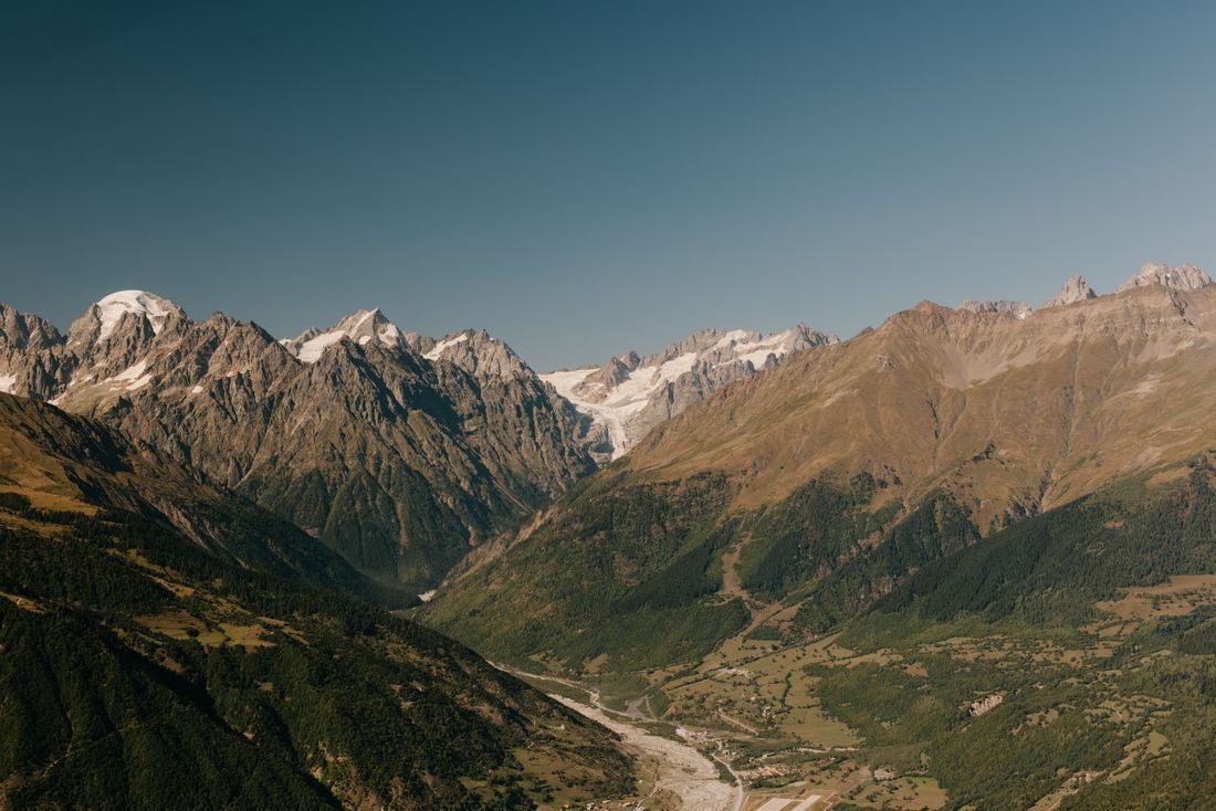 Rocky snow-topped highland valley